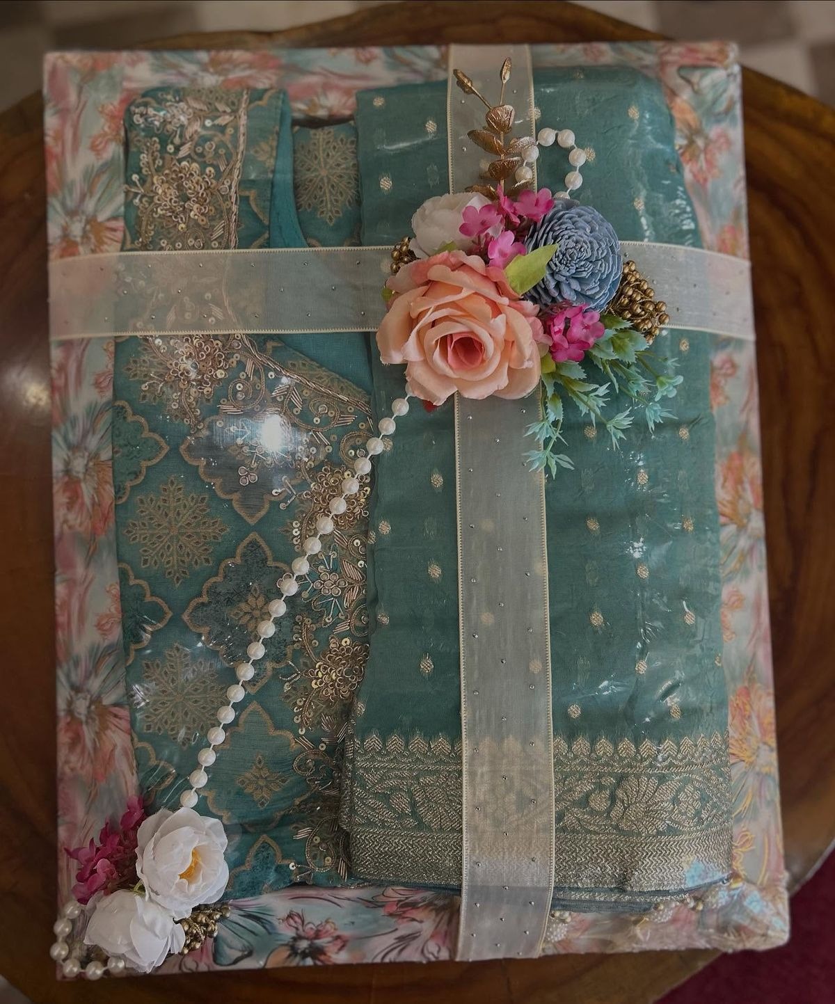 Wrapped festive outfit with pearls and a fresh floral arrangement