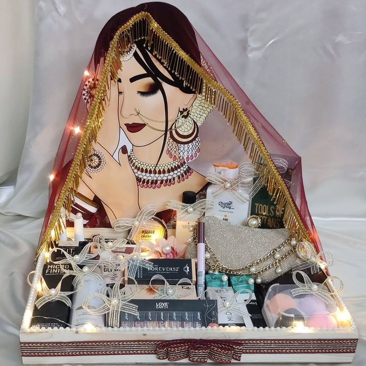 Bridal makeup gift tray with fairy lights and a painted bride veil backdrop