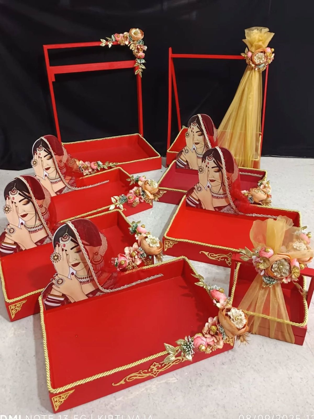 Decorated red wedding gift trays with bride illustration and florals