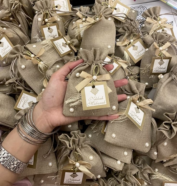 Burlap Nikkah Mubarak favor pouches with pearls and gold tags
